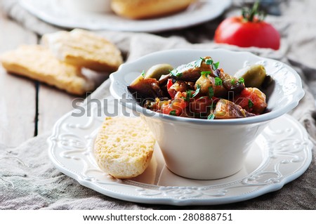 Traditional sicilian dish caponata with eggplant and tomato, selective focus