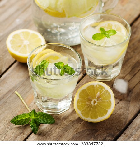 Fresh water with lemon, mint and cucumber, selective focus and square image