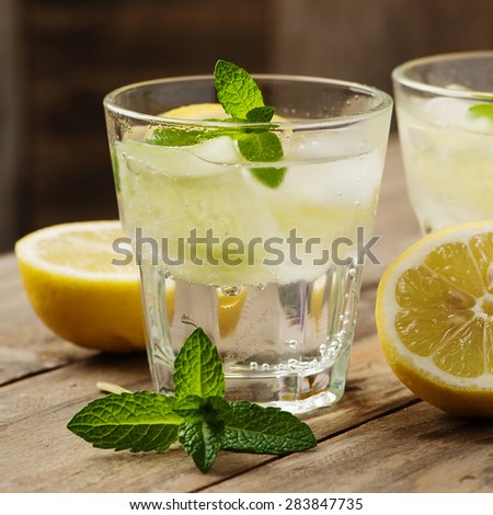 Fresh water with lemon, mint and cucumber, selective focus and square image