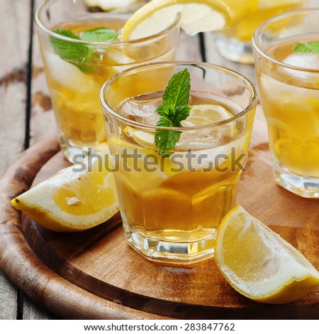 Ice tea with lemon and mint, selective focus and square image