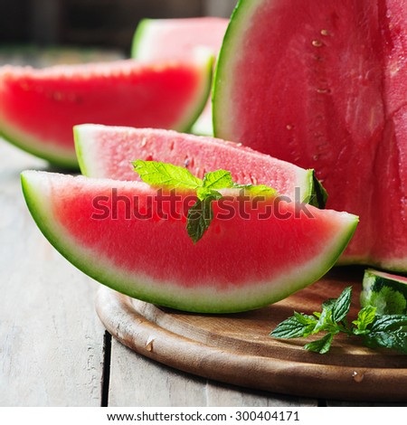 Fresh sweet watermelon on the wooden table, selective focus and square image