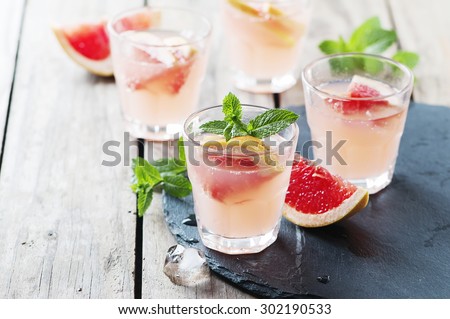 Pink cocktail with ice and mint, selective focus