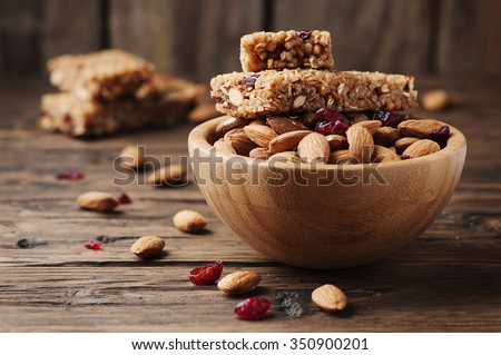 Cereal bar with almond and berry on the wooden table, selective focus