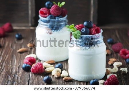 Healthy yogurt with belly and nuts, selective focus
