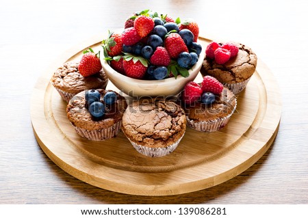 mixed muffins fruits on wooden board on on old table