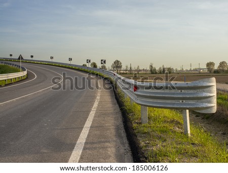 Turn in the road with guard rail on countryside