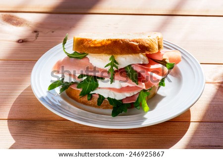 sandwich with ham and cheese in wooden table