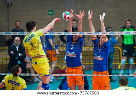 MONZA, ITALY - APRIL 20: Kooistra ( 5) jamping  against a blue wall  in Volley Gabeca Monza ( Blue) vs Volley Modena ( Yellow) -Italian Volley League on 2011 April, 20 in Monza (Italy)