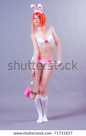 woman easter bunny on gray background with orange hair