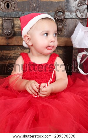 Brunette christmas baby girl wearing a long red tulle dress