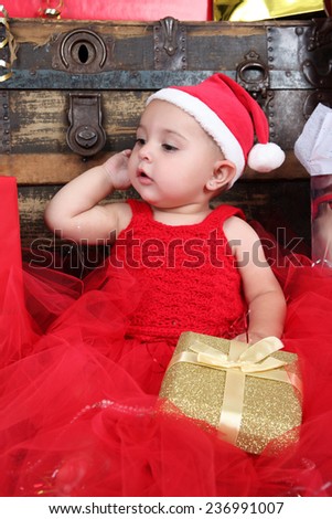 Brunette christmas baby girl wearing a long red tulle dress