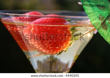 Strawberries in a martini glass with an umbrella