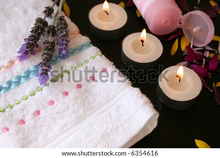 Hand Towel with candles and hand-cream and fresh flowers
