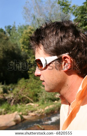 Young male model profile looking down, wearing white sunglasses