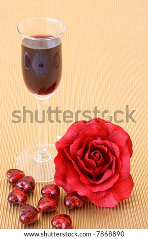 Small after-dinner wine glass with a red rose and glass hearts