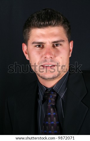 stock photo : Male model in a suit and tie against a dark background
