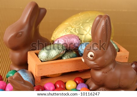 Various colors and shaped easter eggs and chocolate bunnies