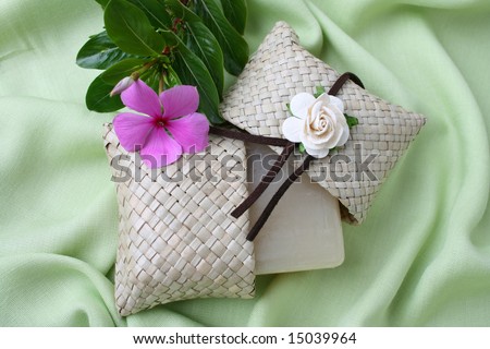 Soap gift in a woven bag with fresh flowers