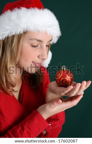 Beautiful teenager wearing a red shirt and christmas hat