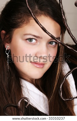 Female teenager looking through wrought iron bars