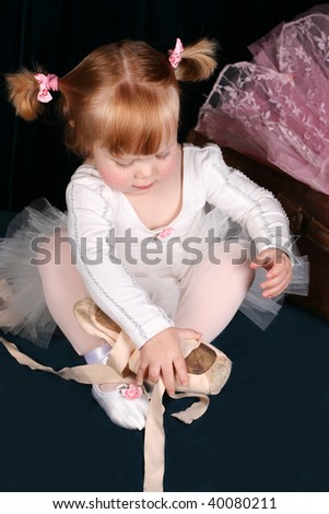 Little ballet toddler wearing a white tutu
