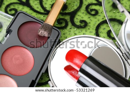 New eyeshadow set with used lipstick and small mirror.  FOCUS ON REFLECTION.