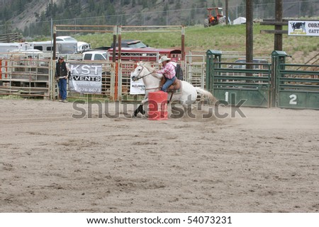 MERRITT, B.C. CANADA - MAY 22: Cowgirl barrel racing event at the Richest Indian Rodeo May 22, 2010 in Merritt British Columbia, Canada