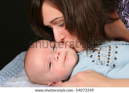 Caucasian mother and son, mother kissing her baby boy