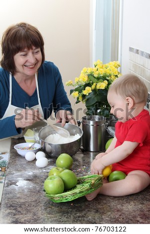 Grandmother and grandson in the kitchen baking cake