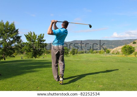 Young male golfer hitting a driver from the tee-box