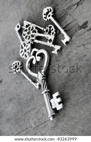 Miniature antique keys on a wooden surface