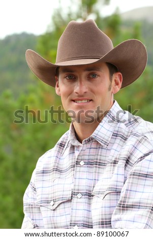 Head shot of a cowboy outside in the field