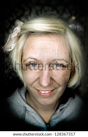 Blonde woman in gray shirt grunge portrait