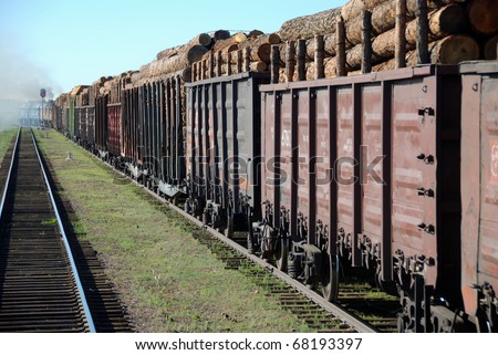 Trans Siberian train transporting wooden logs, cargo and passengers