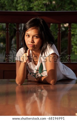 stock photo Pretty Cute Thai Asian Teen relaxes in the sunset