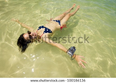 vacation, Asian woman floating in the ocean wear sunglasses and bikini