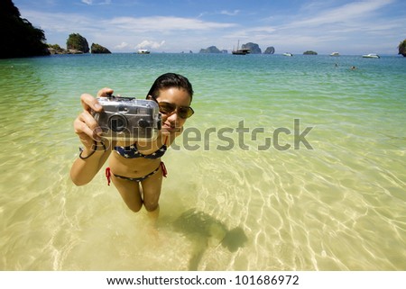 vacation girl, live Asian girl hold camera on the bikini beach