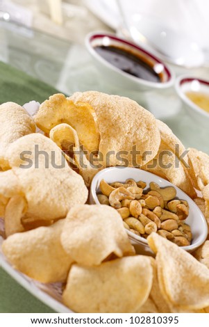 crisp rice, dish of crisp cracker with nuts and sauce