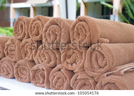 brown towels, brown towels roll neatly for pool side use
