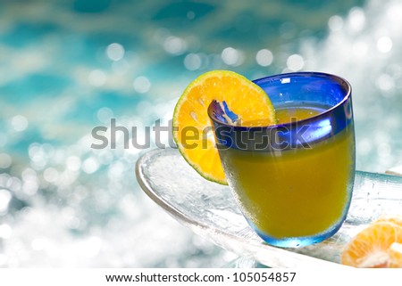 orange cocktail, orange cocktail in blue glass by Jacuzzi pool