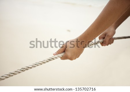 pulling rope, male pulling big rope with two hands