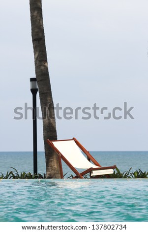 pool side bed, white rest bed on pool side near sea shore