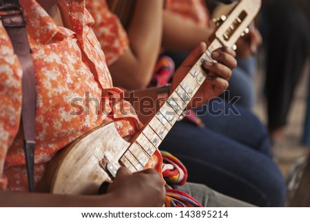 Thai instrument, a man playing Northeastern Thailand stringed lute for instrument band