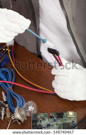 repair man, engineer cleaning computer wire part on work table