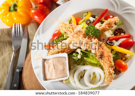 tempura salad, deep fried prawn tempura with vegetable salad on dish decorated dressing