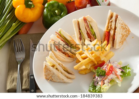 club sandwich, decorated club sandwich side with fried potato and salad