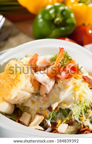 shrimp salad, vegetable salad on top with cooked shrimp