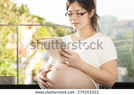 pregnancy, an Asian pregnant woman reading a book