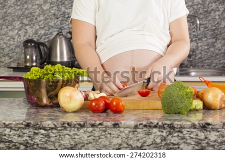 pregnant cook, Asian pregnancy woman cooking salad in the kitchen