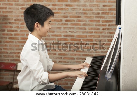 piano lesson, Asian boy kid activity playing piano with notes, smiling